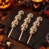 Three marbled milk and white chocolate skull totem pole lollies on wooden sticks, with ribbon and Halloween card